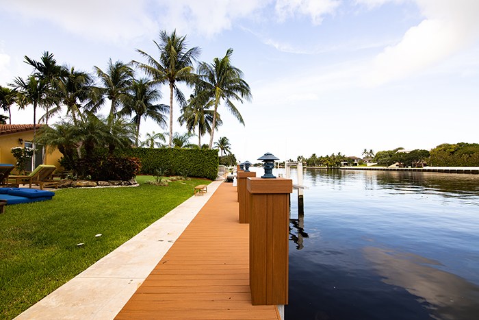 Waterfront lawn, dock and palms on a South Florida waterway
